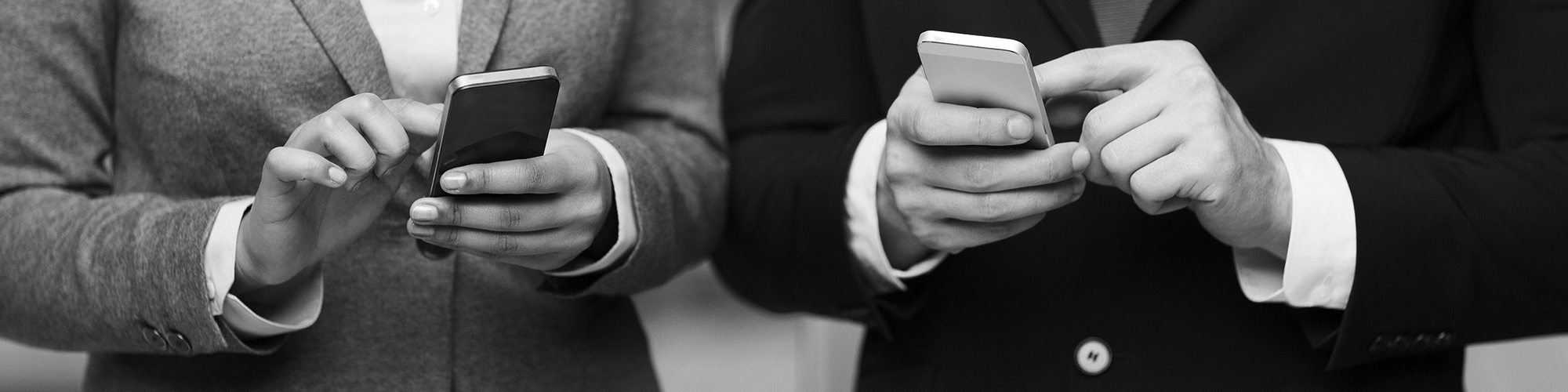 Image of two people's hands holding mobile phones